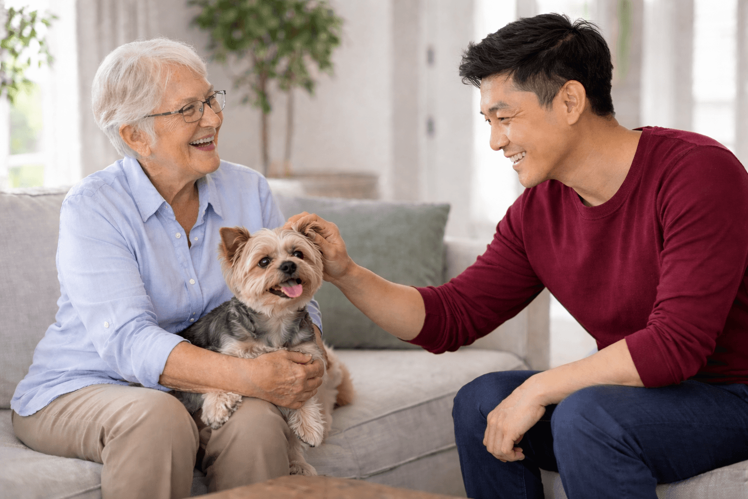 Caregiver and elderly woman with dog on couch | senior transportation services Philadelphia | Neighborly Home Care