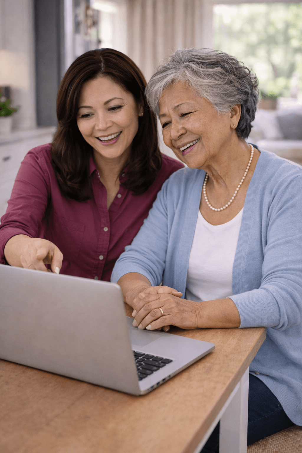 Caregiver and elderly woman smiling while looking at laptop | home care Philadelphia PA | Neighborly Home Care
