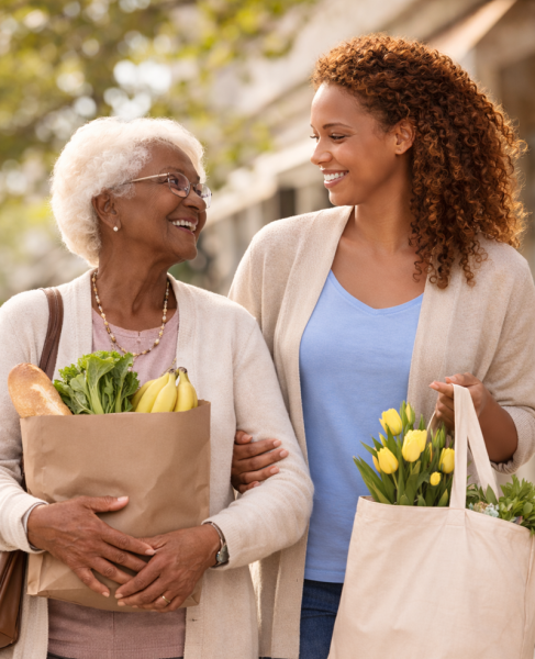 Elderly woman and caregiver holding groceries | senior home care Center City Philadelphia | Neighborly Home Care